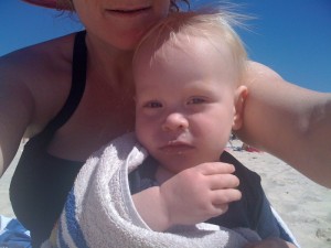 snuggling after a swim at the beach with mum